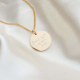 Disc shaped necklace engraved with handwriting
